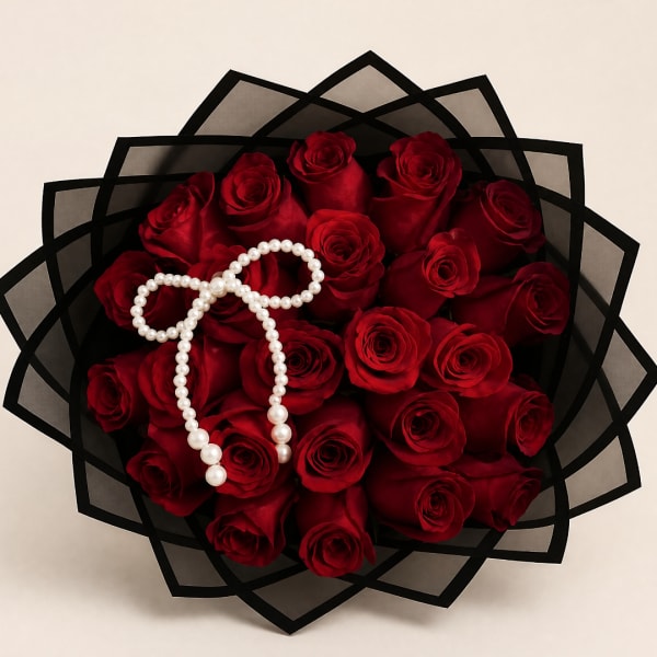 Bouquet of red roses wrapped in black paper with a pearl necklace