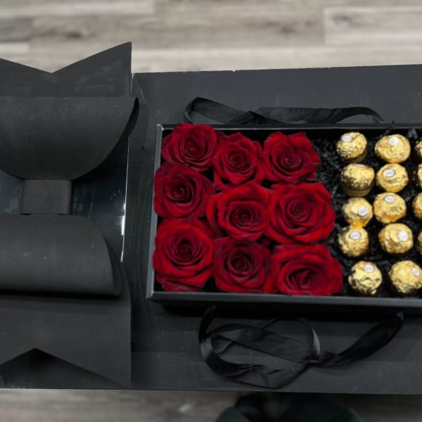 Red roses and gold chocolates in a black gift box