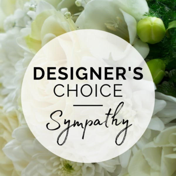 White floral arrangement with a sympathy label