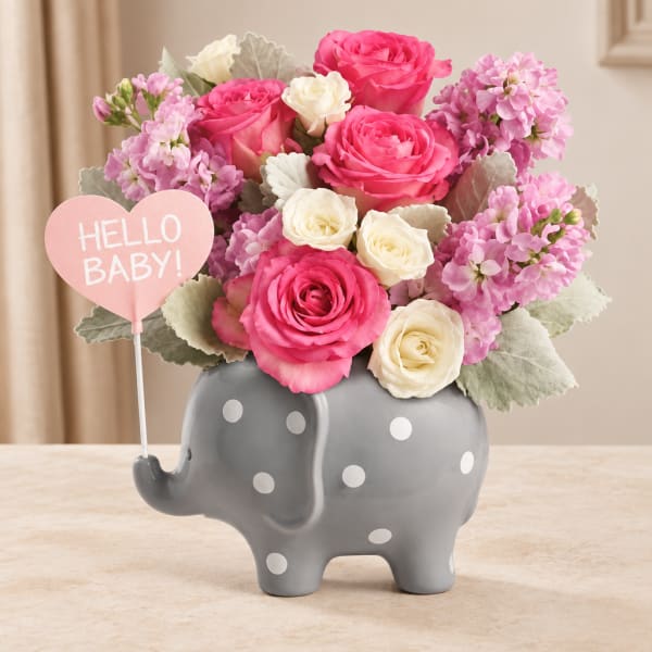 Pink and white roses in a gray polka-dot elephant vase with a "Hello Baby!" sign