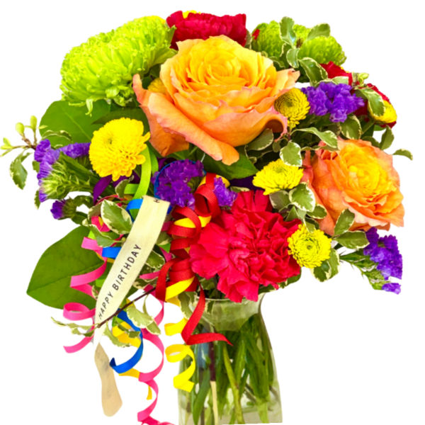 Colorful bouquet with roses, mums, and ribbon in a glass vase