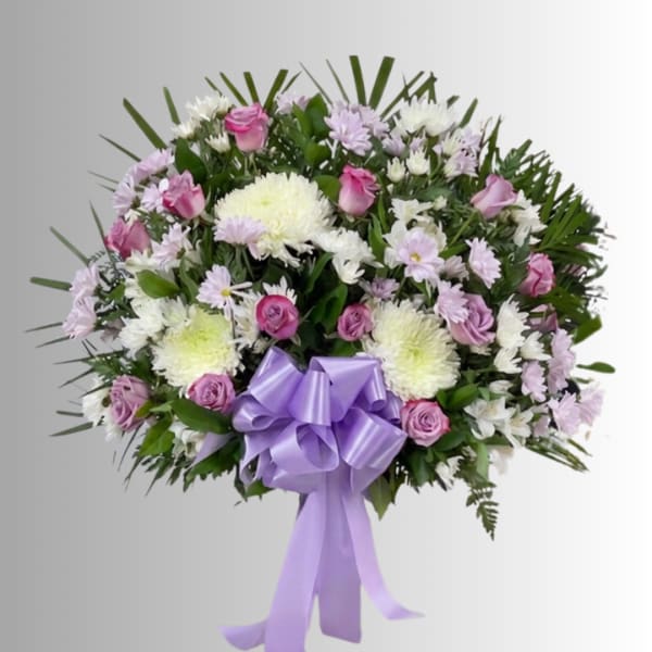 Lavender and white floral spray with a purple ribbon bow