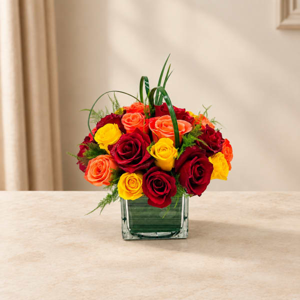 Mixed roses in a square glass vase