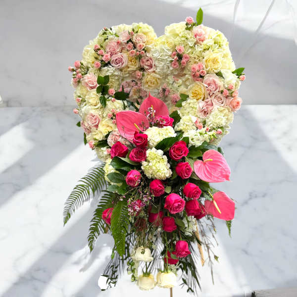 Heart-shaped floral arrangement with pink roses and white hydrangeas