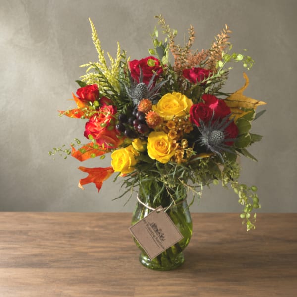 Mixed bouquet of red and yellow roses in a glass vase