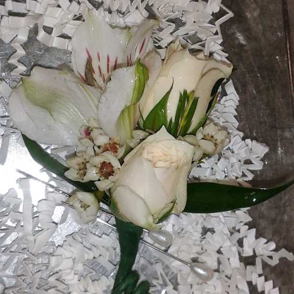 White rose and lily bouquet with small white filler flowers