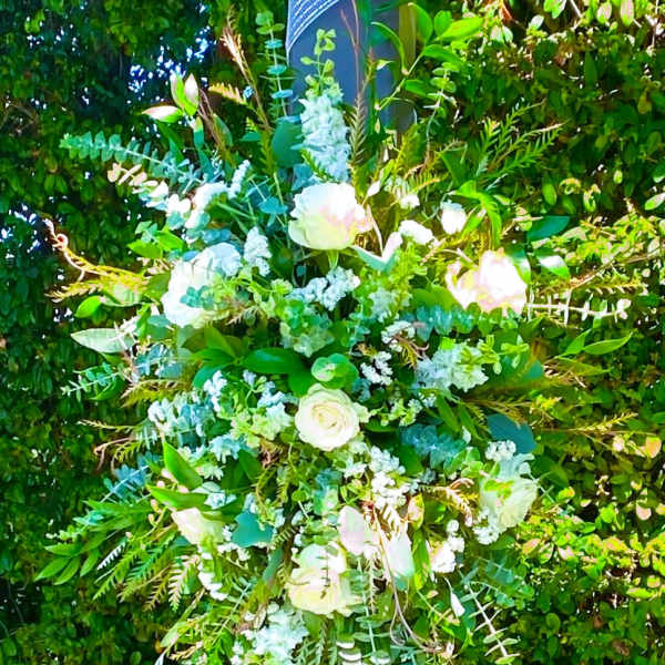Large floral arrangement with white roses and pale blue flowers