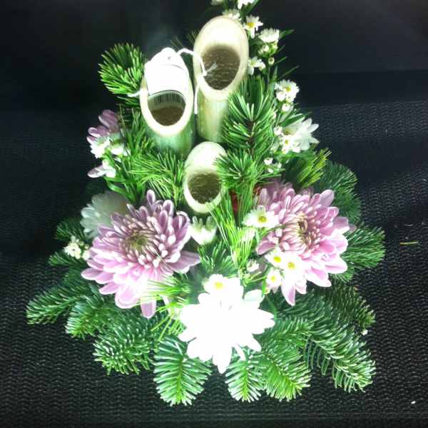 Floral arrangement with pink chrysanthemums, white daisies, and bamboo stems
