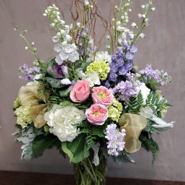 Mixed bouquet with pink, white, and lavender flowers in a decorative arrangement