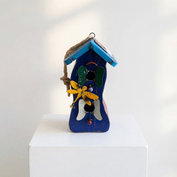 Blue wooden birdhouse with painted butterfly decorations