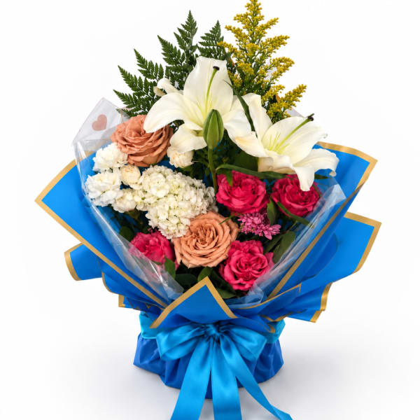 Bouquet of white lilies, roses, and mixed blooms wrapped in blue paper