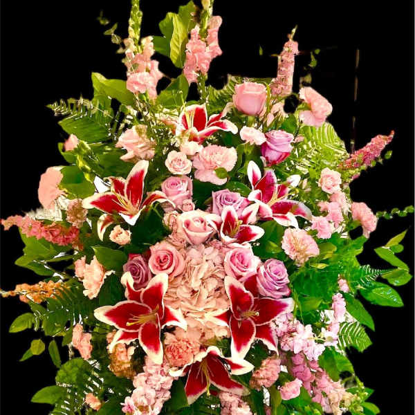 Tall standing floral spray with pink roses and red lilies