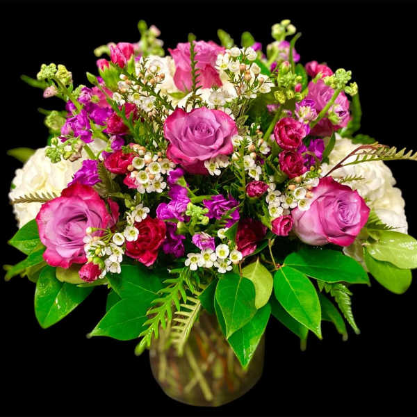 Bouquet of pink and white roses in a glass vase