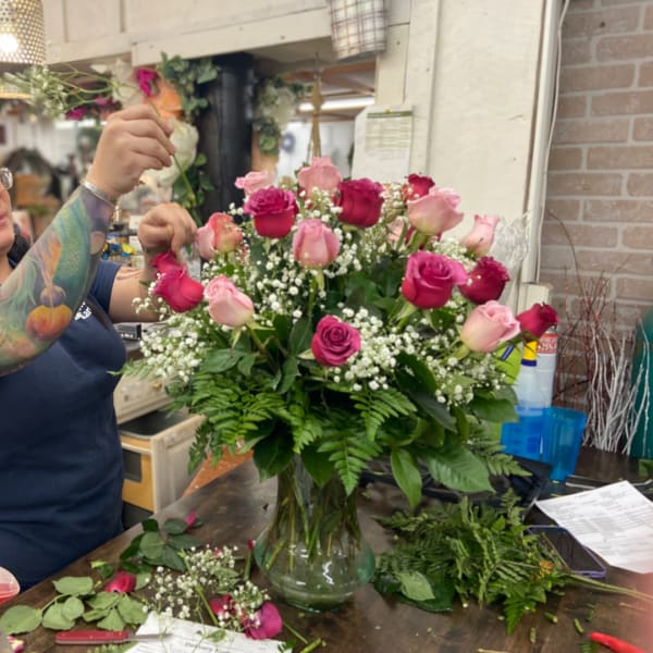 Pink and red rose arrangement in a glass vase