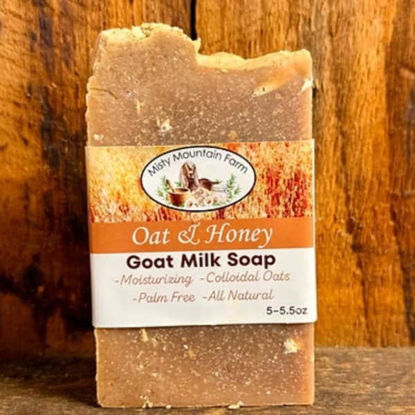 Bar of oat and honey goat milk soap with a paper label