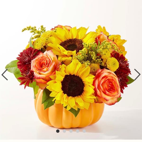 Sunflower and rose arrangement in a pumpkin-shaped container