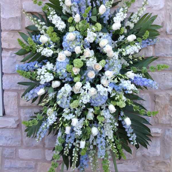 Large standing floral spray with white roses and blue flowers