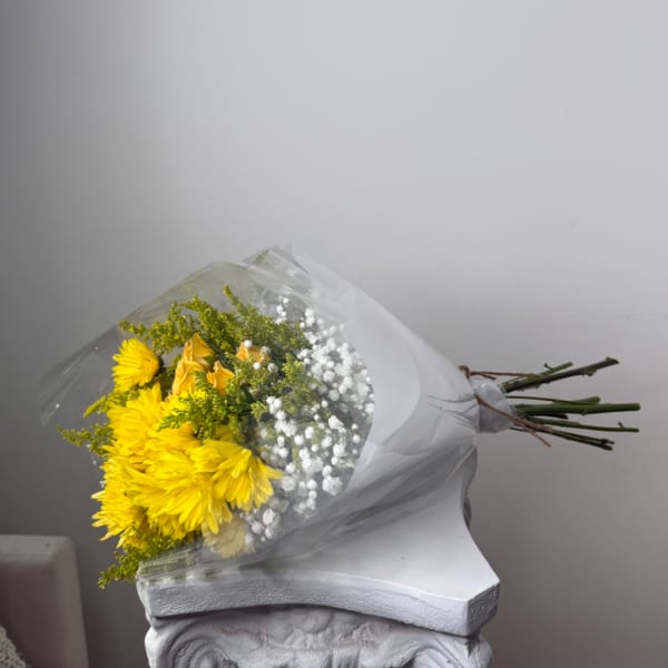 Bouquet of yellow flowers wrapped in clear plastic