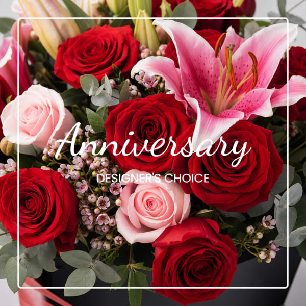 Red and pink roses with a pink lily in a black box