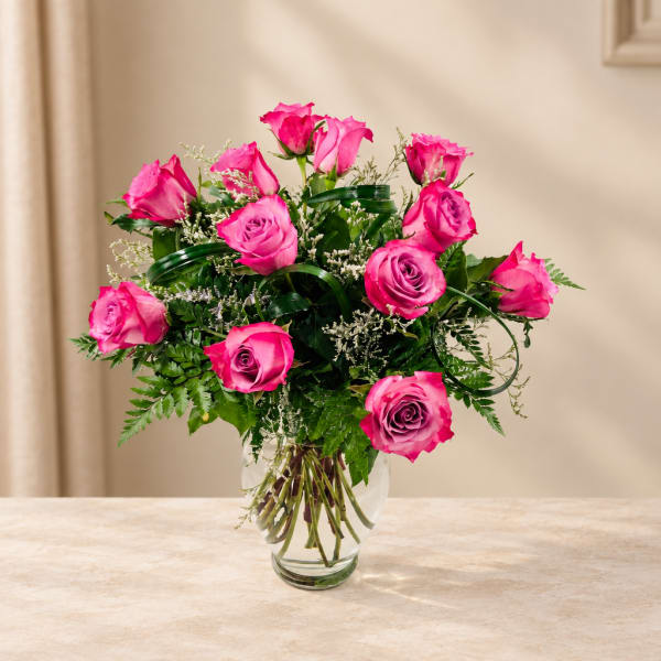 Pink roses arranged in a clear glass vase