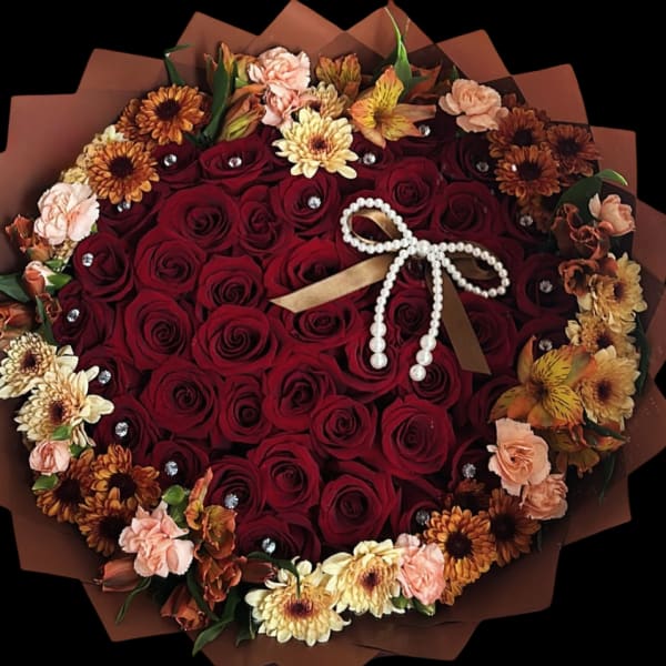 Heart-shaped bouquet of red roses with peach and yellow flowers