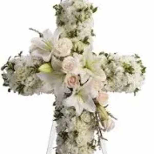 White floral cross on a stand