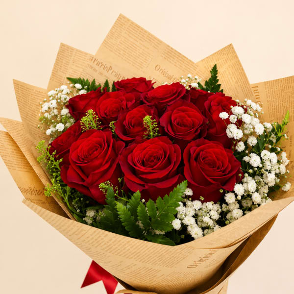 Bouquet of red roses with white baby's breath in brown paper wrap