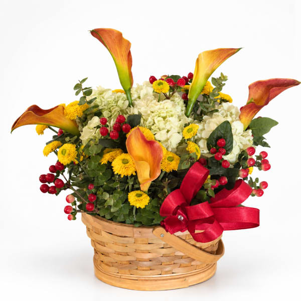 Basket arrangement with orange calla lilies, white hydrangeas, and yellow mums