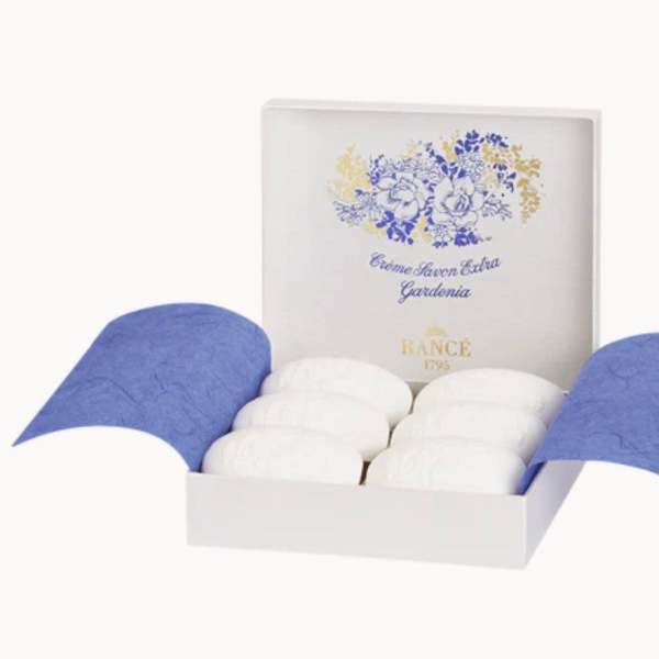 Box of white soaps with blue floral packaging