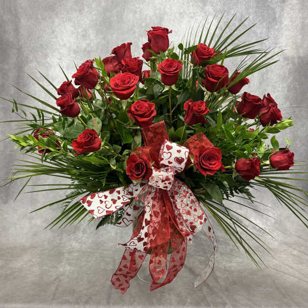 Red roses arranged with a heart-patterned ribbon