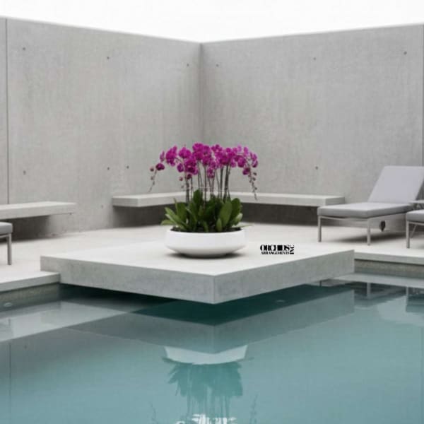 Purple orchids in a white bowl on a modern patio by a pool