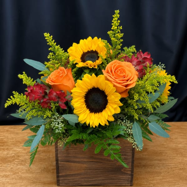 Sunflower and orange rose arrangement in a wooden box