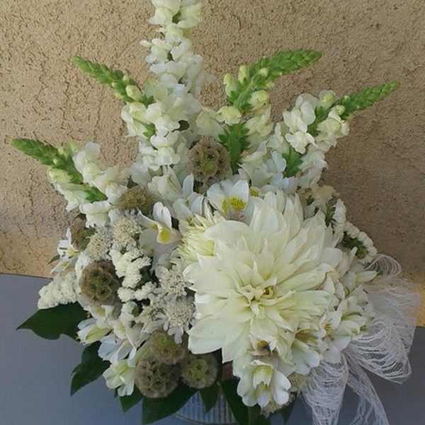 White floral arrangement with tall snapdragons and a large dahlia