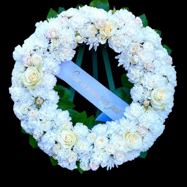 White floral wreath with roses and chrysanthemums on a black background
