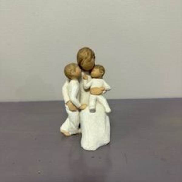 Small figurine of a woman holding two children