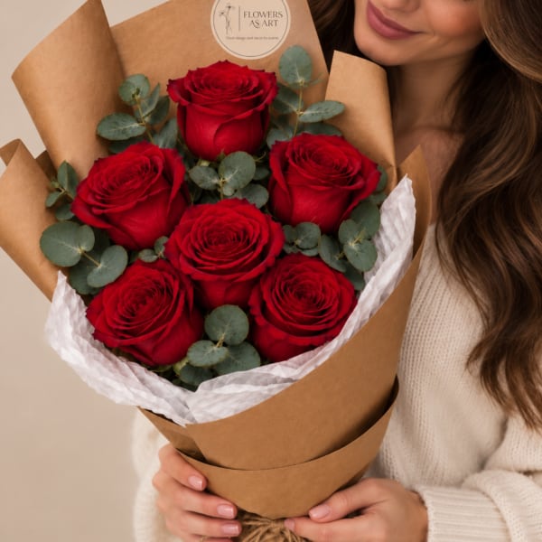 Bouquet of red roses wrapped in brown paper with white tissue