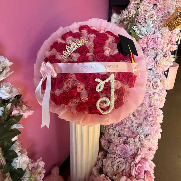 Pink and red rose bouquet with a graduation cap and tiara