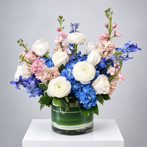 Blue and white floral arrangement in a glass vase