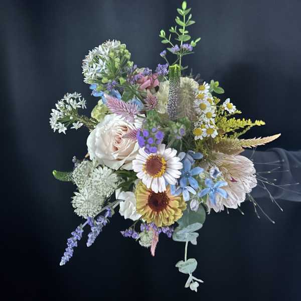 Mixed pastel bouquet with daisies, roses, and airy filler flowers