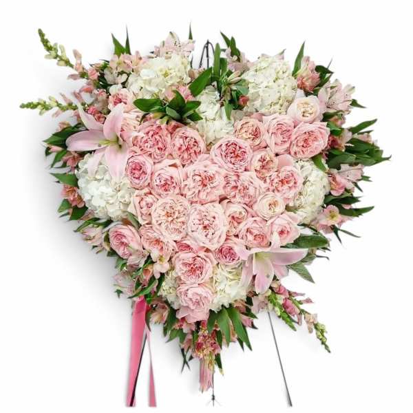 Heart-shaped pink and white floral spray on an easel