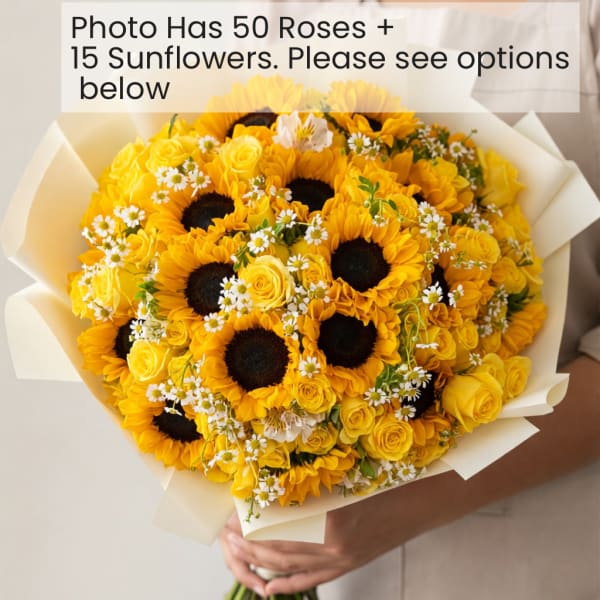 Yellow bouquet with sunflowers, roses, and small white daisies wrapped in cream paper