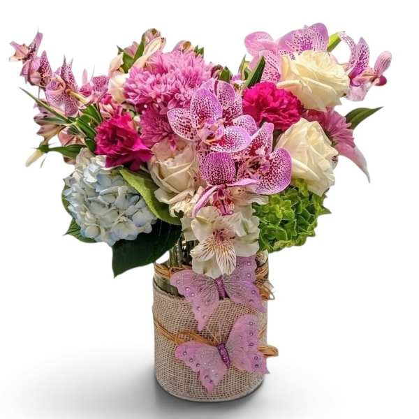 Pink and white mixed bouquet in a burlap-wrapped vase with butterfly decorations