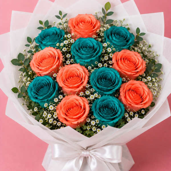 Bouquet of coral and teal roses wrapped in white paper with a satin bow