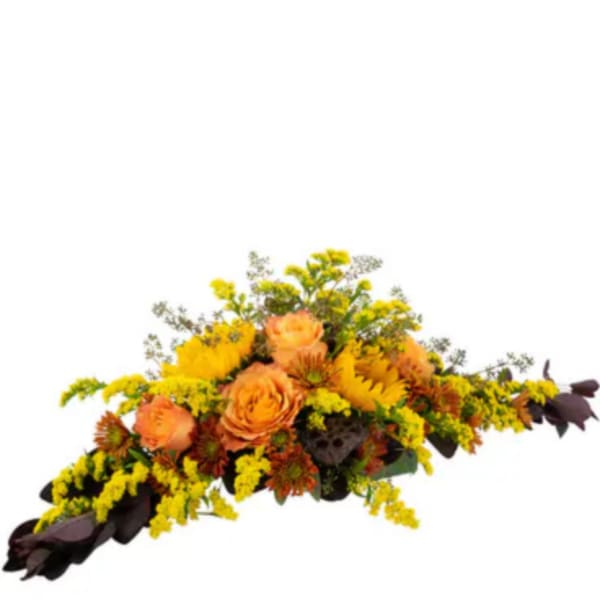 Orange roses and yellow flowers arranged in a low centerpiece