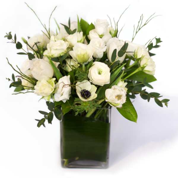 White floral bouquet in a square glass vase
