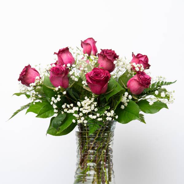 Pink roses and baby's breath in a clear glass vase