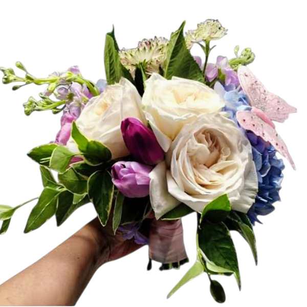 Handheld bouquet of white roses, tulips, and pastel hydrangeas
