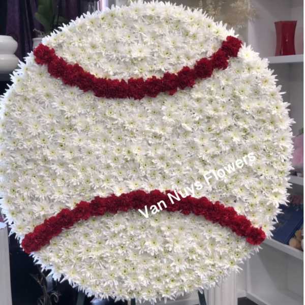 Large white chrysanthemum funeral wreath with red floral bands
