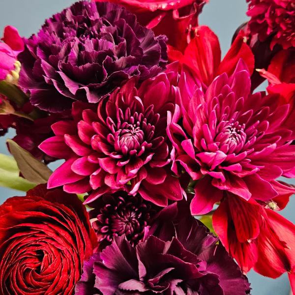 Close-up of red and magenta flowers in a bouquet