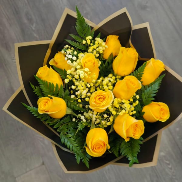 Bouquet of yellow roses with small white filler flowers